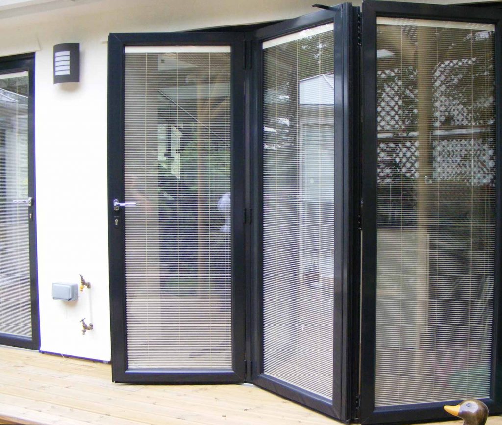 Black aluminium bifold door with integral blinds