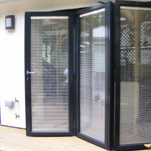 Black aluminium bifold door with integral blinds