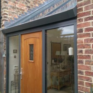 Timber effect composite door and aluminium entrance hall